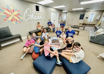 A group kids sitting on the floor